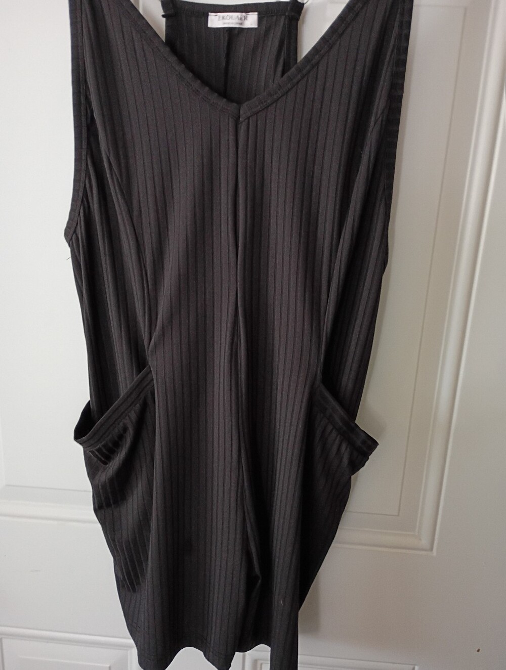 Black Ribbed V-Neck Sleeveless Shorts with Pockets. 90% Polyester 10% Spandex